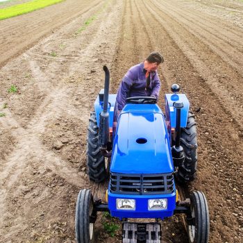 A,Farmer,On,A,Tractor,Cultivates,A,Farm,Field.,Soil